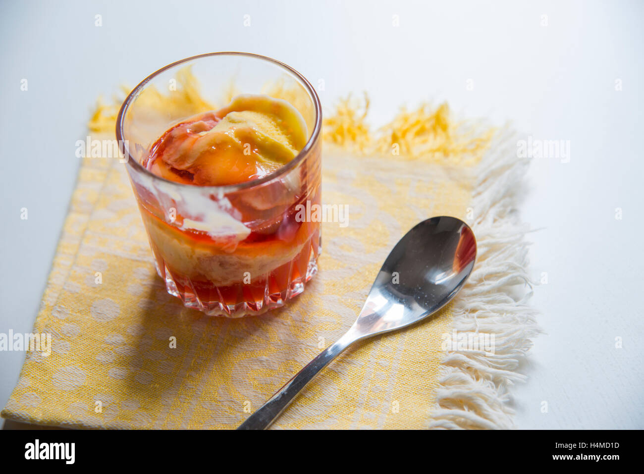 Mango ice cream with strawberry jam. Stock Photo