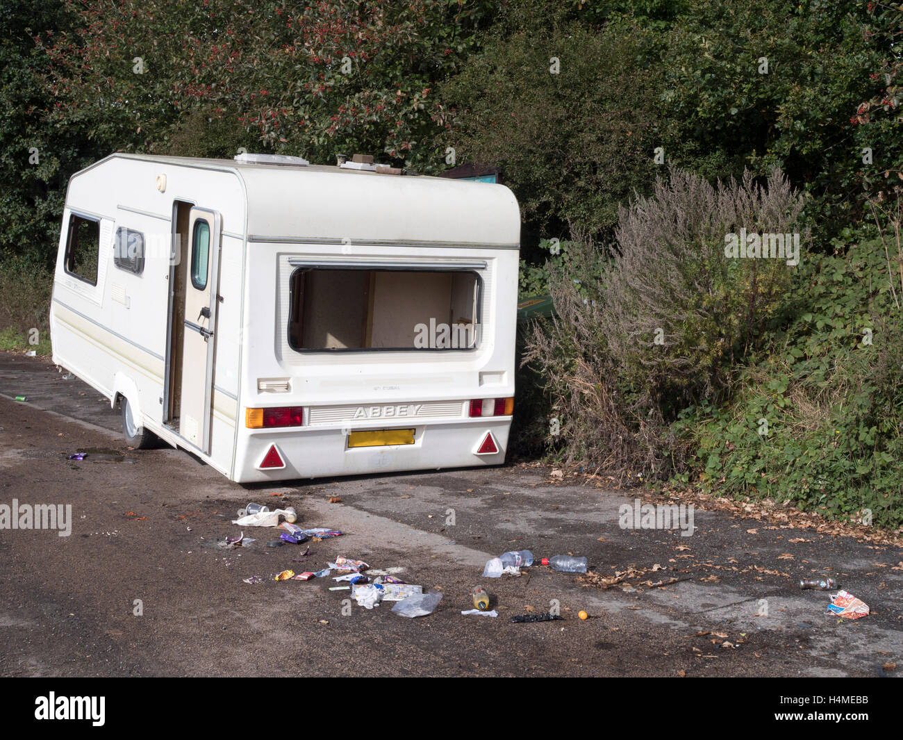 Derelict caravan dumped in roadside lay-bye. Stock Photo