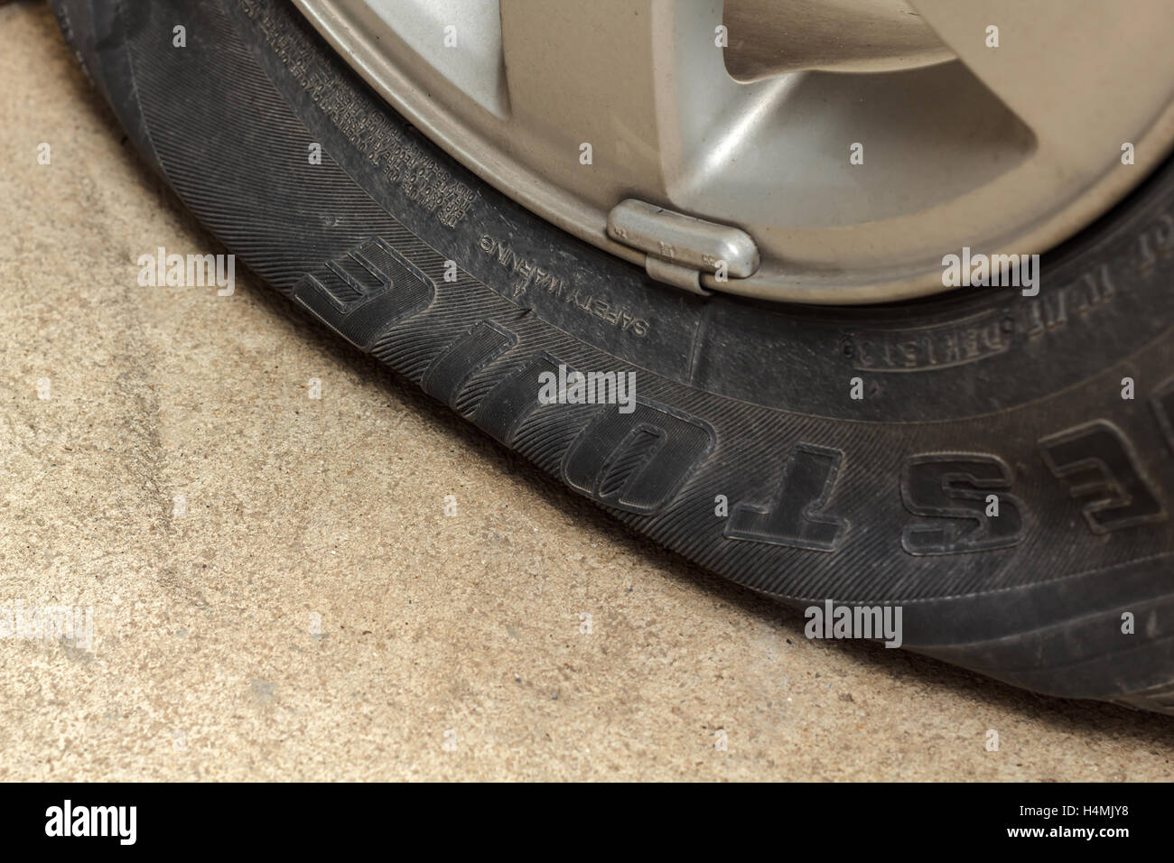 car wheel flat tire on the road Stock Photo Alamy