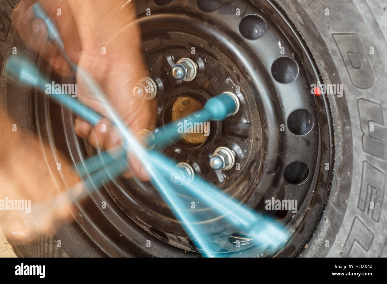 Changing tire with wheel wrench Stock Photo Alamy