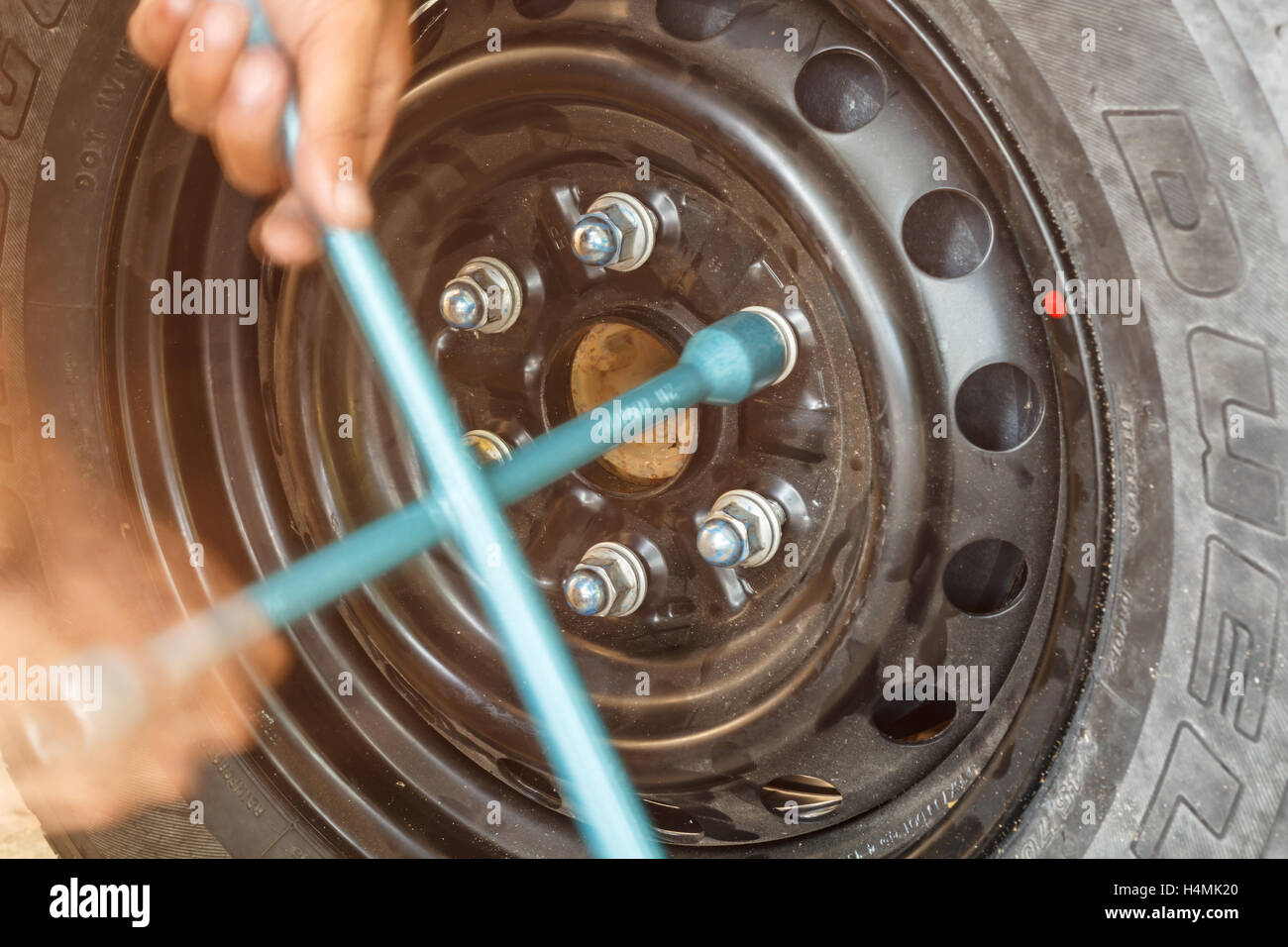 Changing tire with wheel wrench Stock Photo - Alamy - Asphalt Tire Changing With A Wheel Chocks