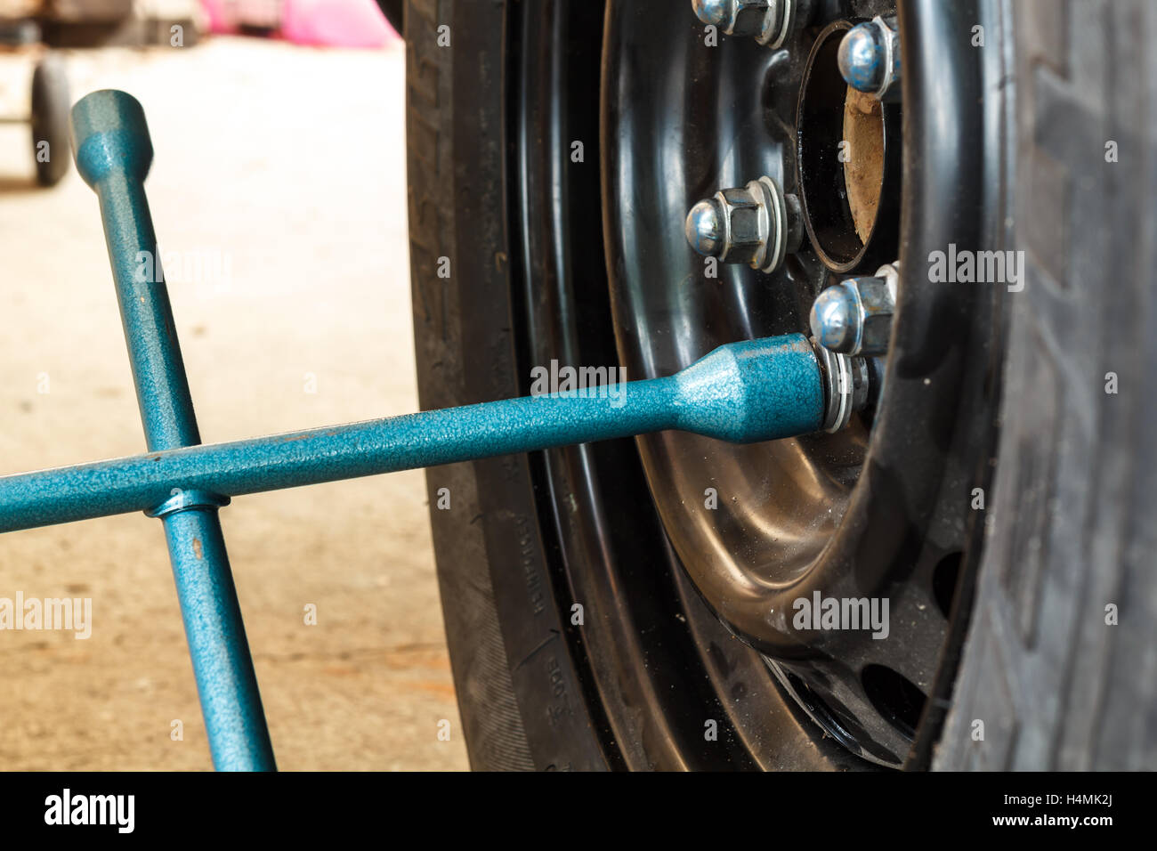 Changing tire with wheel wrench Stock Photo Alamy