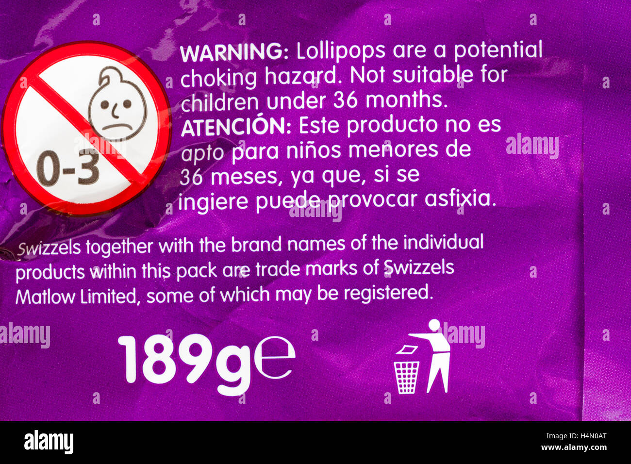 Warning lollipops are a potential choking hazard not suitable for children under 36 months - information on pack of Swizzels loadsa chews Stock Photo