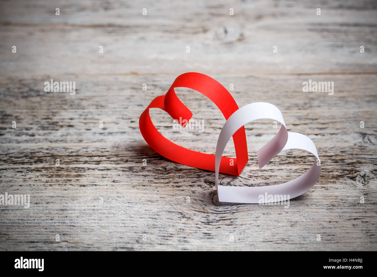 Hearts made of paper on painted wooden background Stock Photo - Alamy