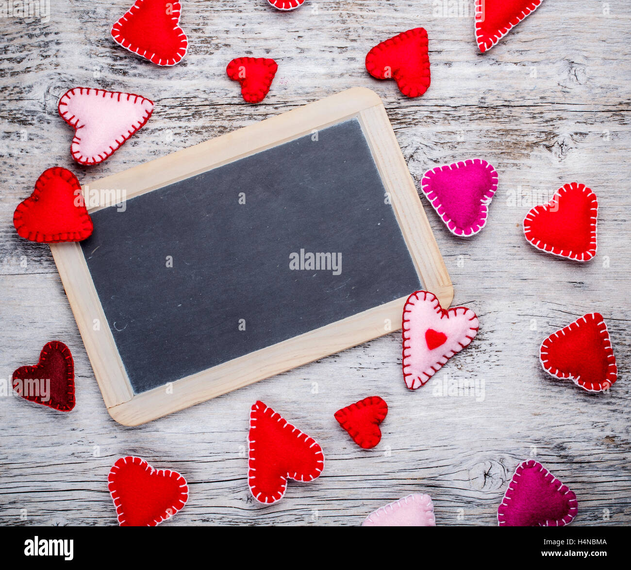 Chalkboard with felt hearts used as a symbol of love Stock Photo