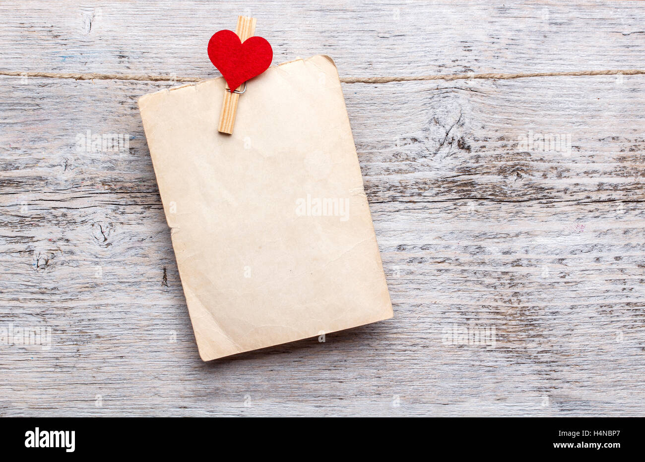Paper hanging on rope, clothespeg with heart Stock Photo