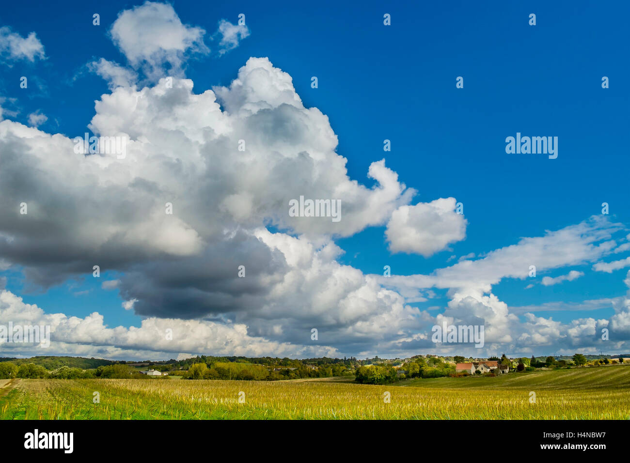Summer sky with Cumulus and Cumulonimbus Calvus rain clouds - France. Stock Photo