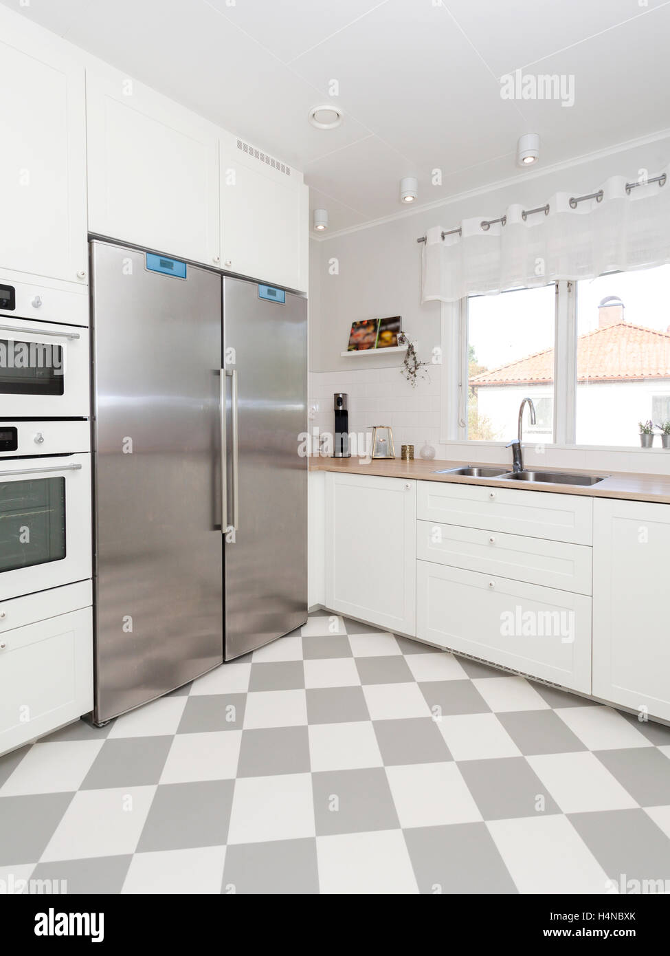 stylish clean kitchen interior with checkered floor Stock Photo