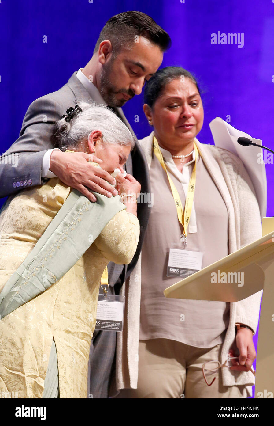 Lawyer Aawer Anwar, who represented the family of murdered Sikh waiter Surjit Singh Chhokar, addresses delegates at the SNP conference in Glasgow, with Surjit's mother Gurder Kaur Chhokar (left) and sister Manjit Sangha. PRESS ASSOCIATION Photo. Picture date: Saturday October 15, 2016. See PA story POLITICS SNP. Photo credit should read: Jane Barlow/PA Wire Stock Photo