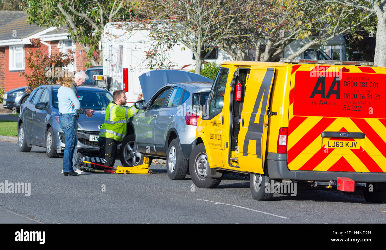 AA recovery van and mechanic at a broken down car in the UK. AA rescue service. Stock Photo