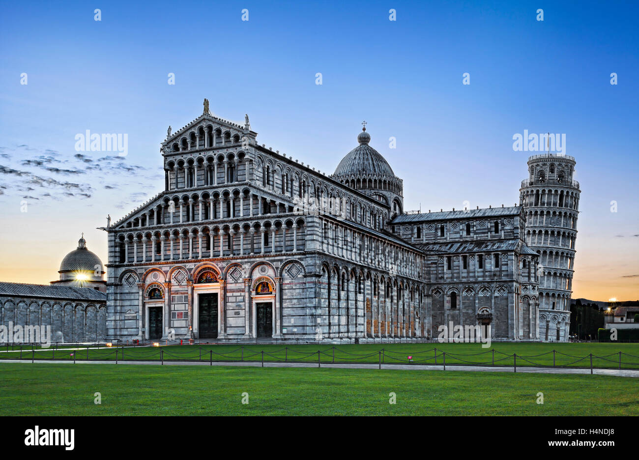 Italian ancient landmark Cathedral and leaning tower of Pisa - architectural ensemble at sunrise. Stock Photo