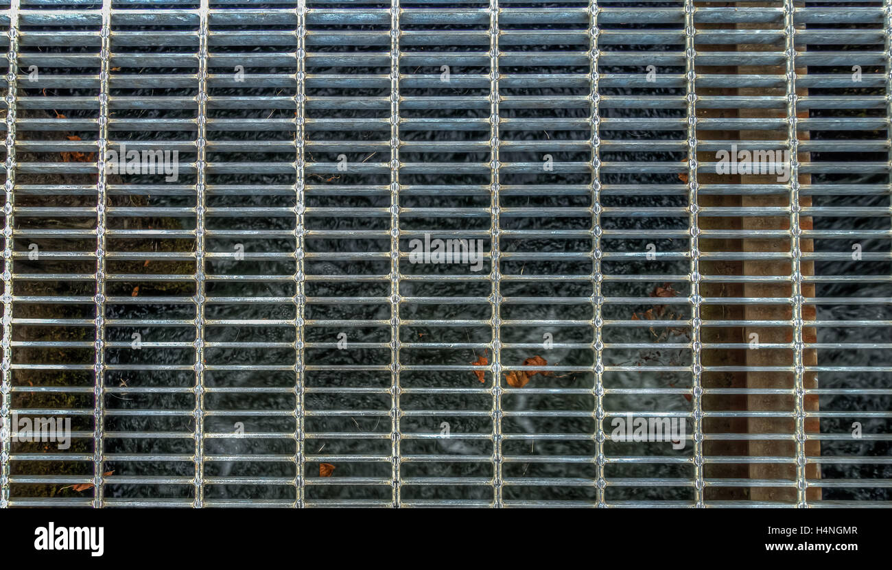 HDR image of a metal grate over water. Stock Photo