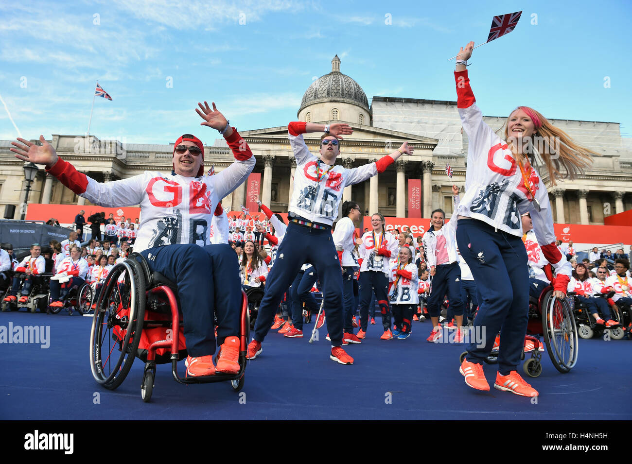 Team GB Olympic and Paralympic athletes celebrate on stage during the