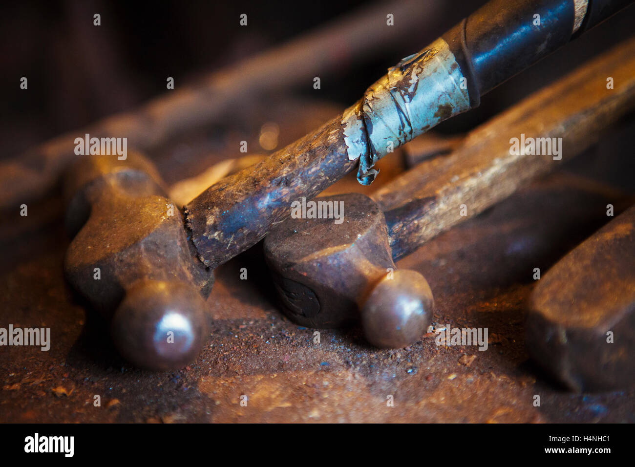 Close up of metal hammers lying in a blacksmith's workshop. Stock Photo
