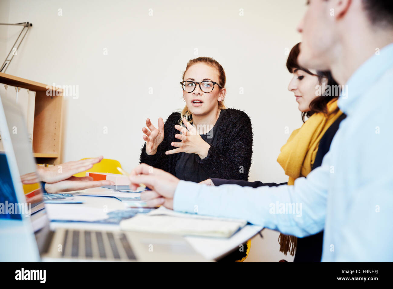 Three people at a business meeting, two women and a man. Stock Photo