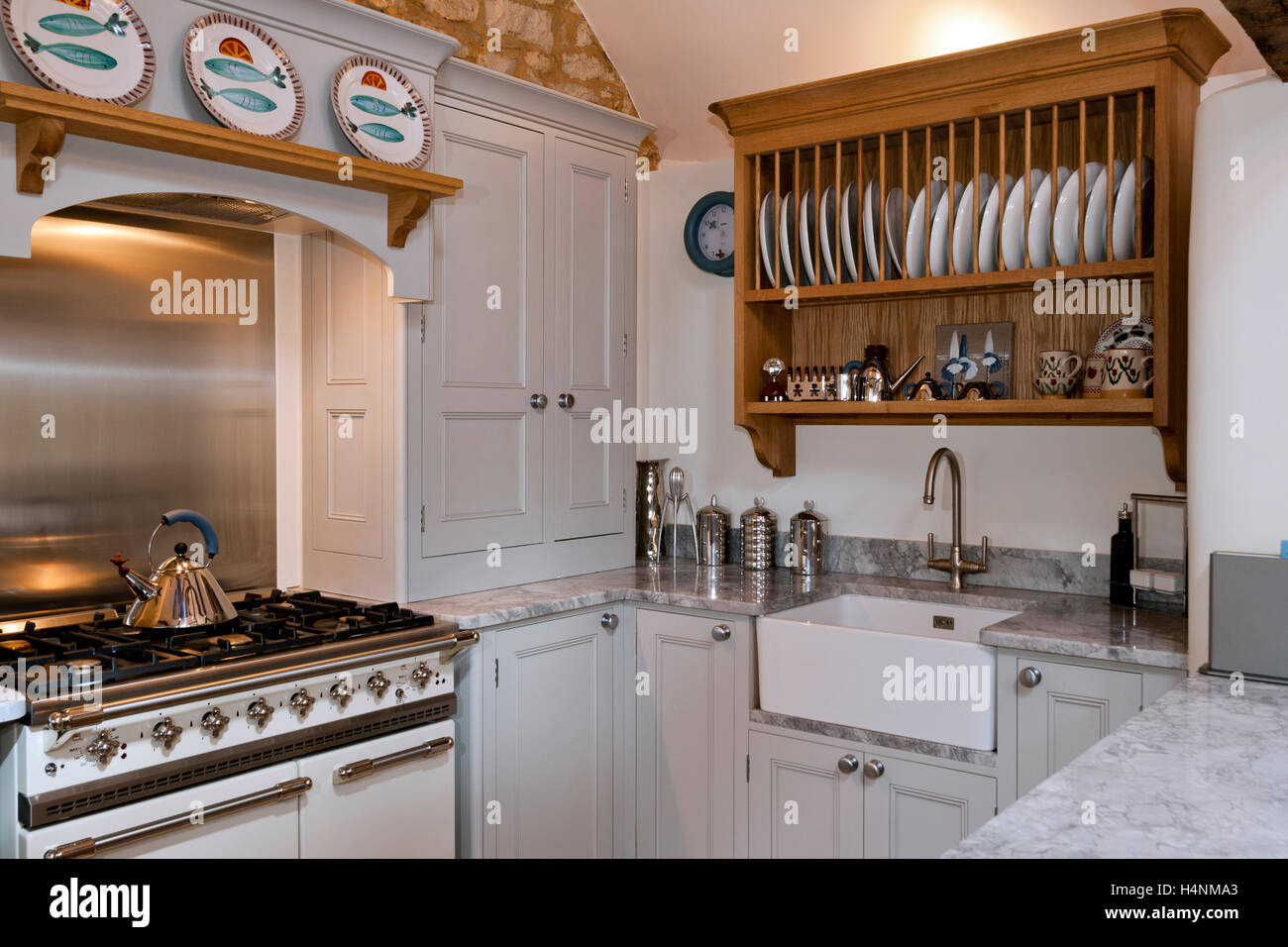 Contemporary paint finished fitted kitchen with a range cooker Stock