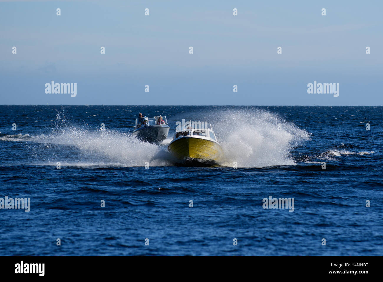 Small boats on the waves with splashing water, Mandal, Norway Stock Photo
