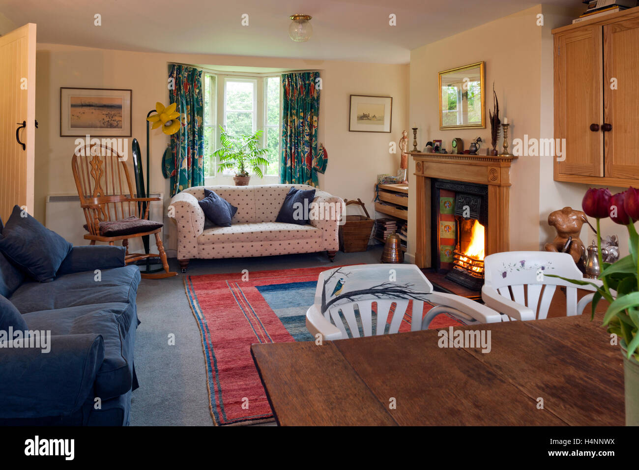 A traditionally furnished sitting room with an open fire Stock Photo