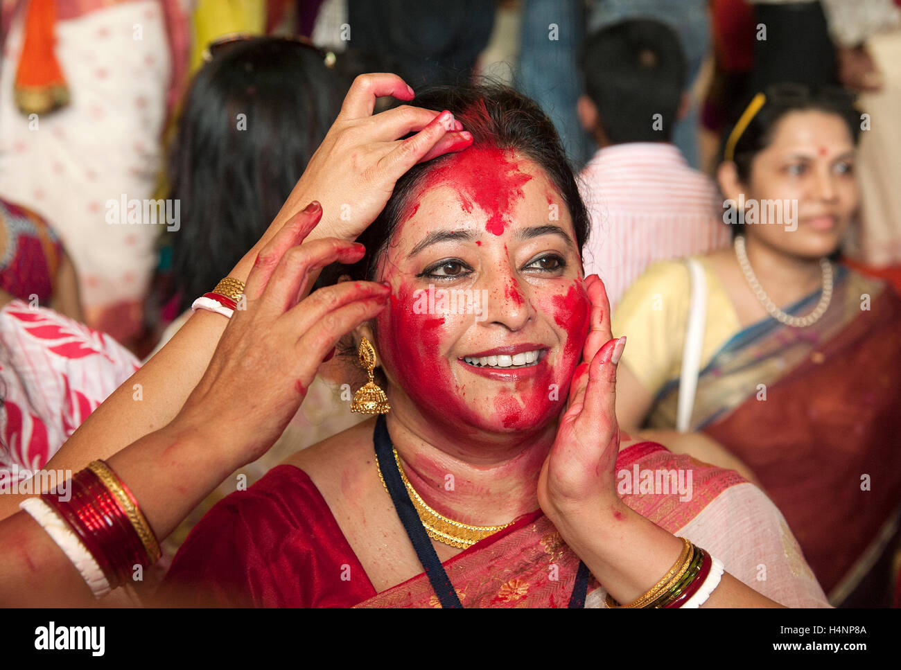 The image of Bengali Woman hindu devotee playing sindoor khela on the traditional festival of Bijoya Dasami, Dussehra, Mumbai, I Stock Photo