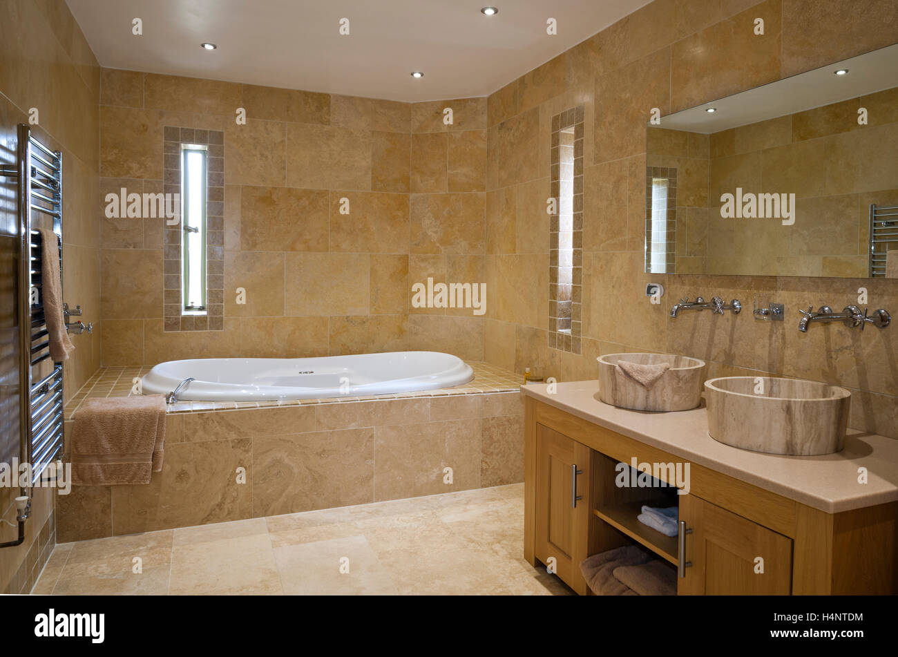 A luxury tiled bathroom with his and hers wash basins Stock Photo