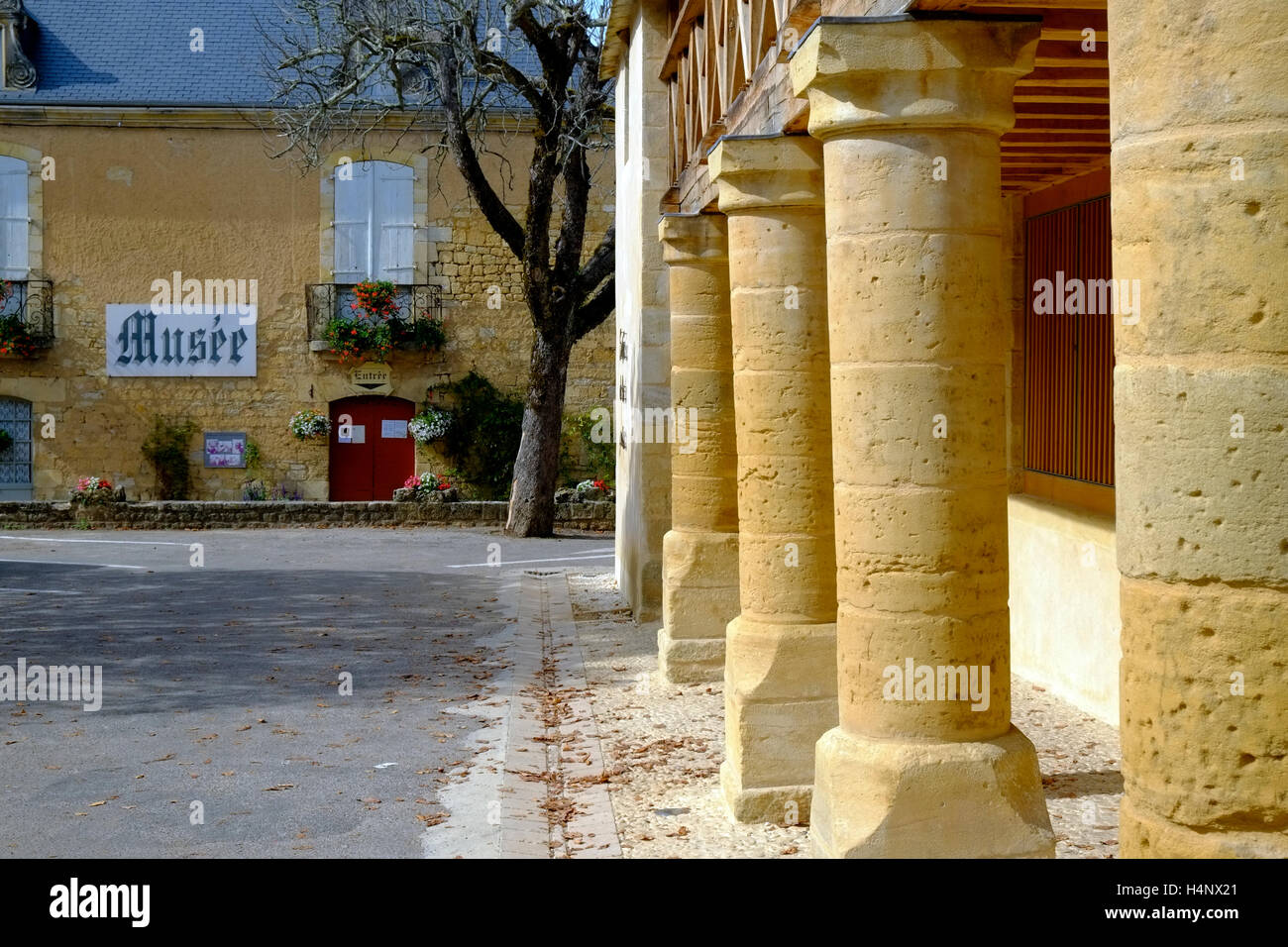A picturesque street scene in autumn sunshine, the museum closes at lunchtime, Domme, Aquitane, France Stock Photo