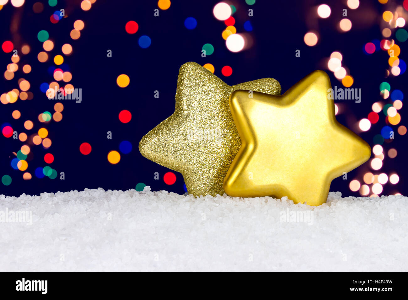 Golden stars on snow background Stock Photo - Alamy