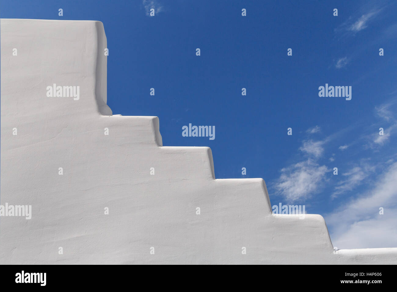 whitewashed staircase on Santorini over blue sky Stock Photo