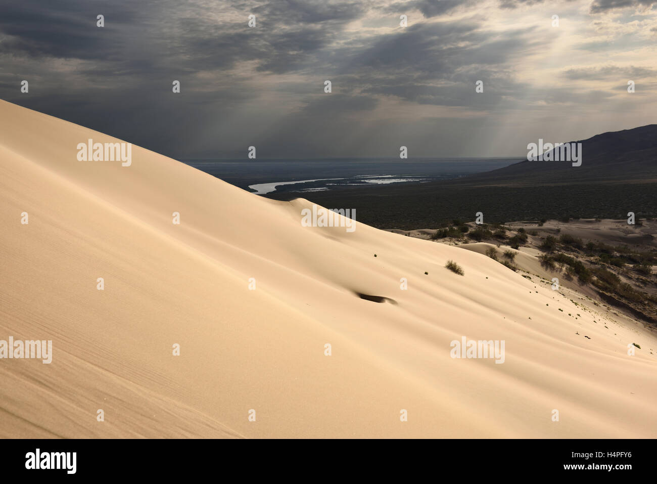 Golden sand at Singing Sand Dune Altyn Emel Park with Ili River and Kishi  Kalkan mountain Kazakhstan Stock Photo - Alamy