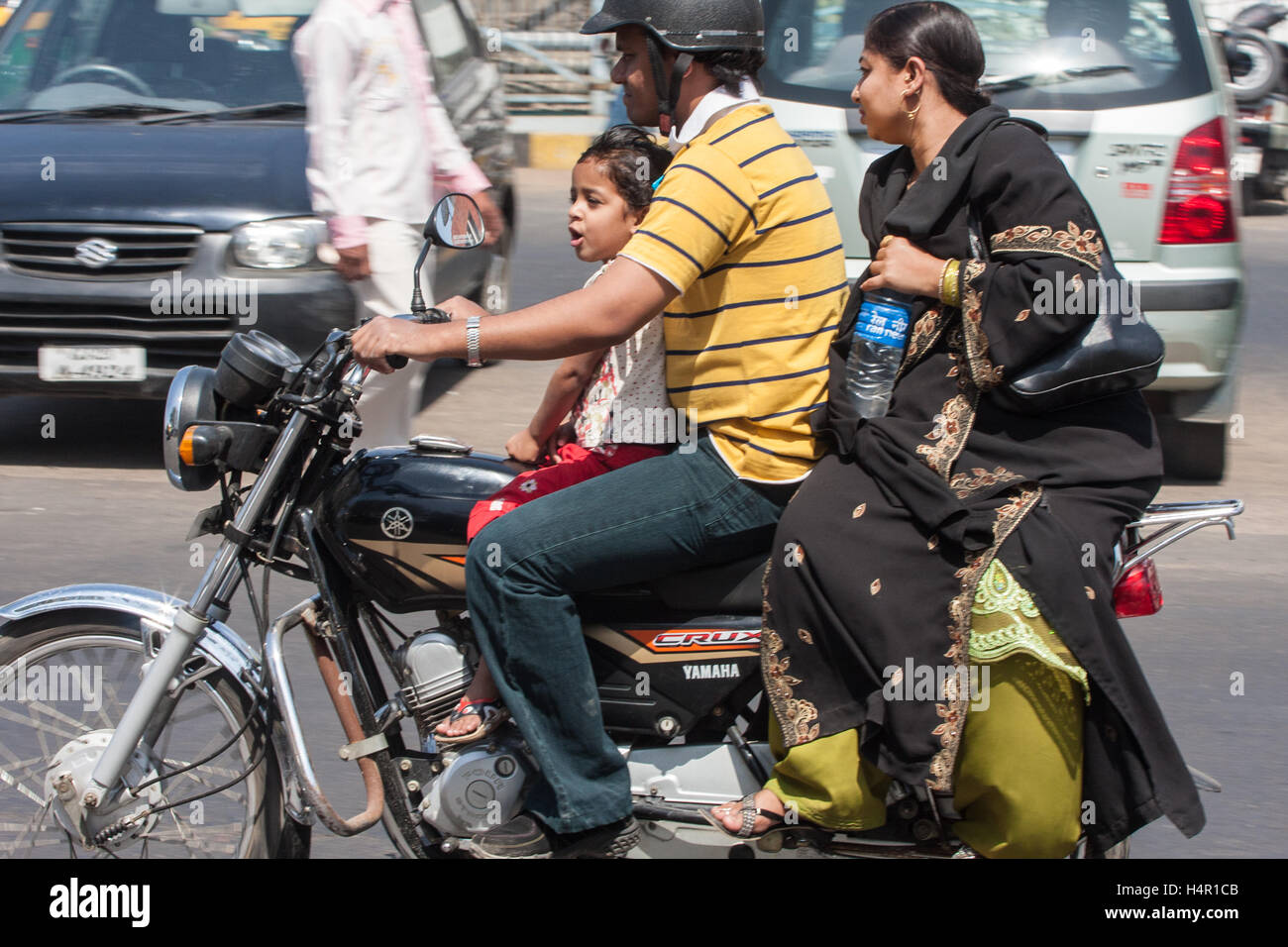 Family riding driving on a scooter motorbike in centre of Ahmedabad,Gujurat. Stock Photo
