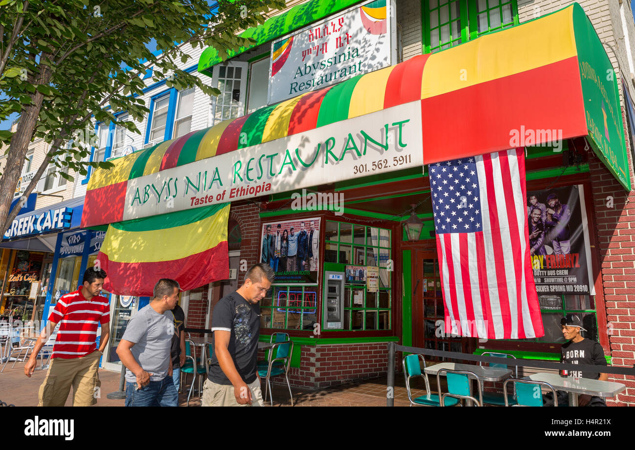 SILVER SPRING, MARYLAND, USA - People walk by Abyssinia Ethiopian Restaurant on Georgia Avenue. American flag and Ethiopia flag. Stock Photo