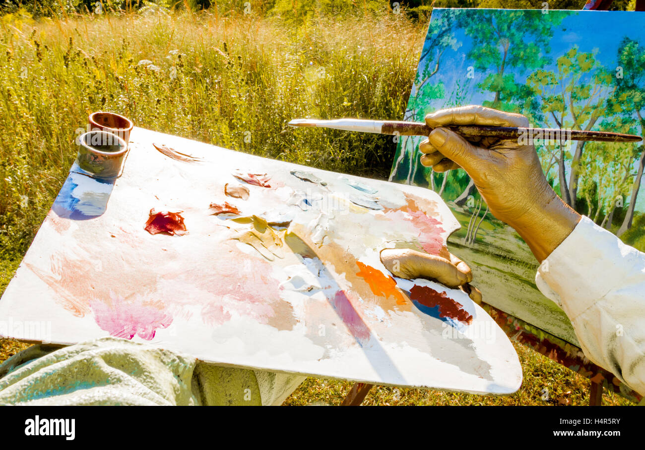 Part of sculpture - Artist brush in one hand and the color oil palette holding in another hand, New Jersey park, USA Stock Photo