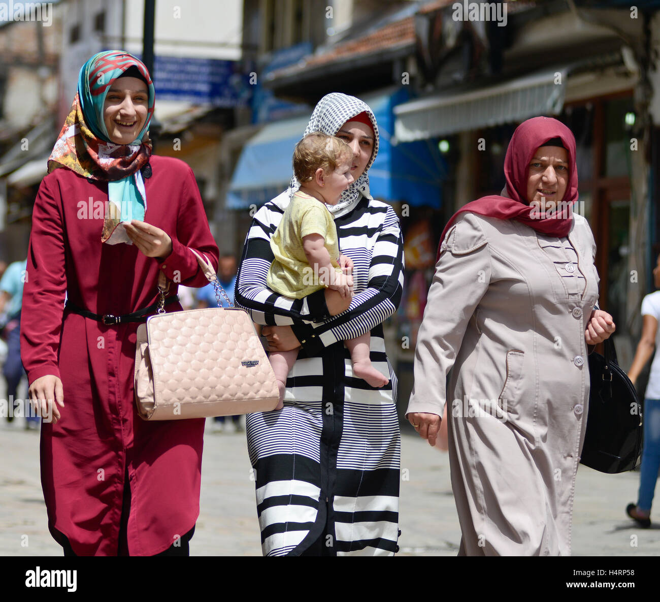 Muslim women with a baby. Skopje, Old Bazaar, Macedonia Stock Photo