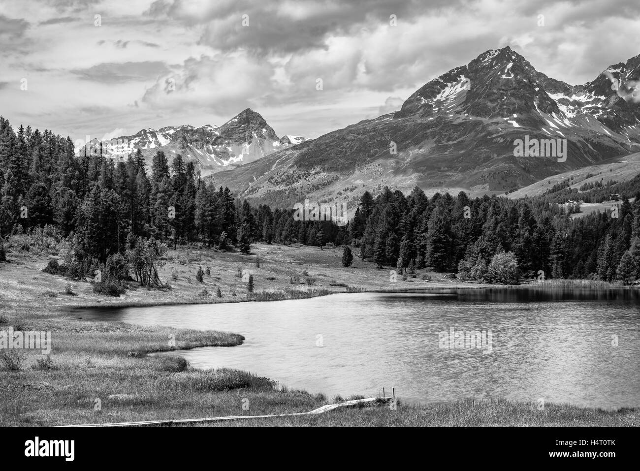 Alpine scenery with lake in the mountains of the Swiss Alps in black and white fine-art Stock Photo