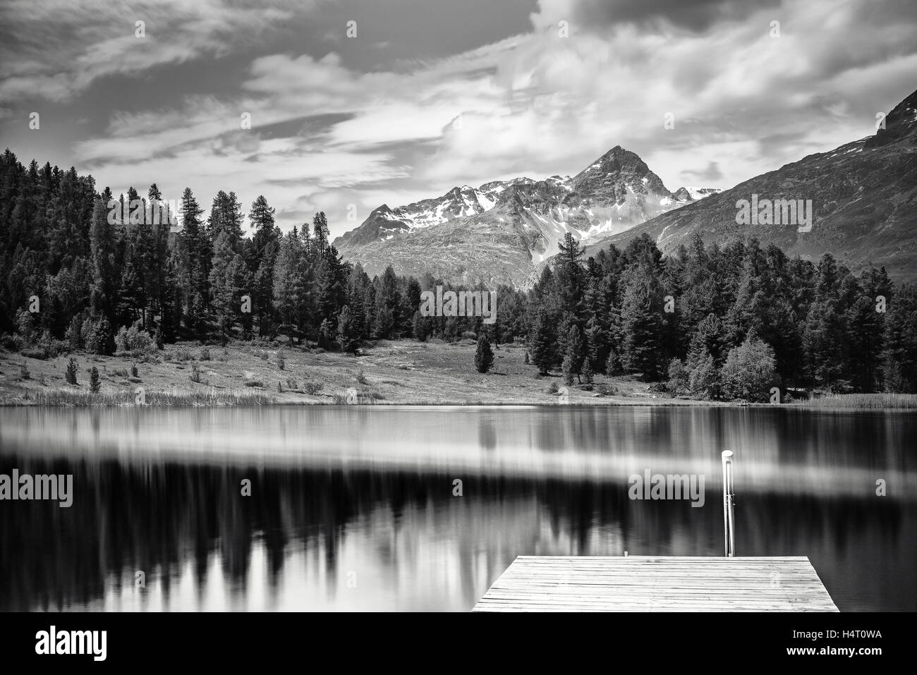 Alpine scenery with lake in the mountains of the Swiss Alps in black and white fine-art Stock Photo