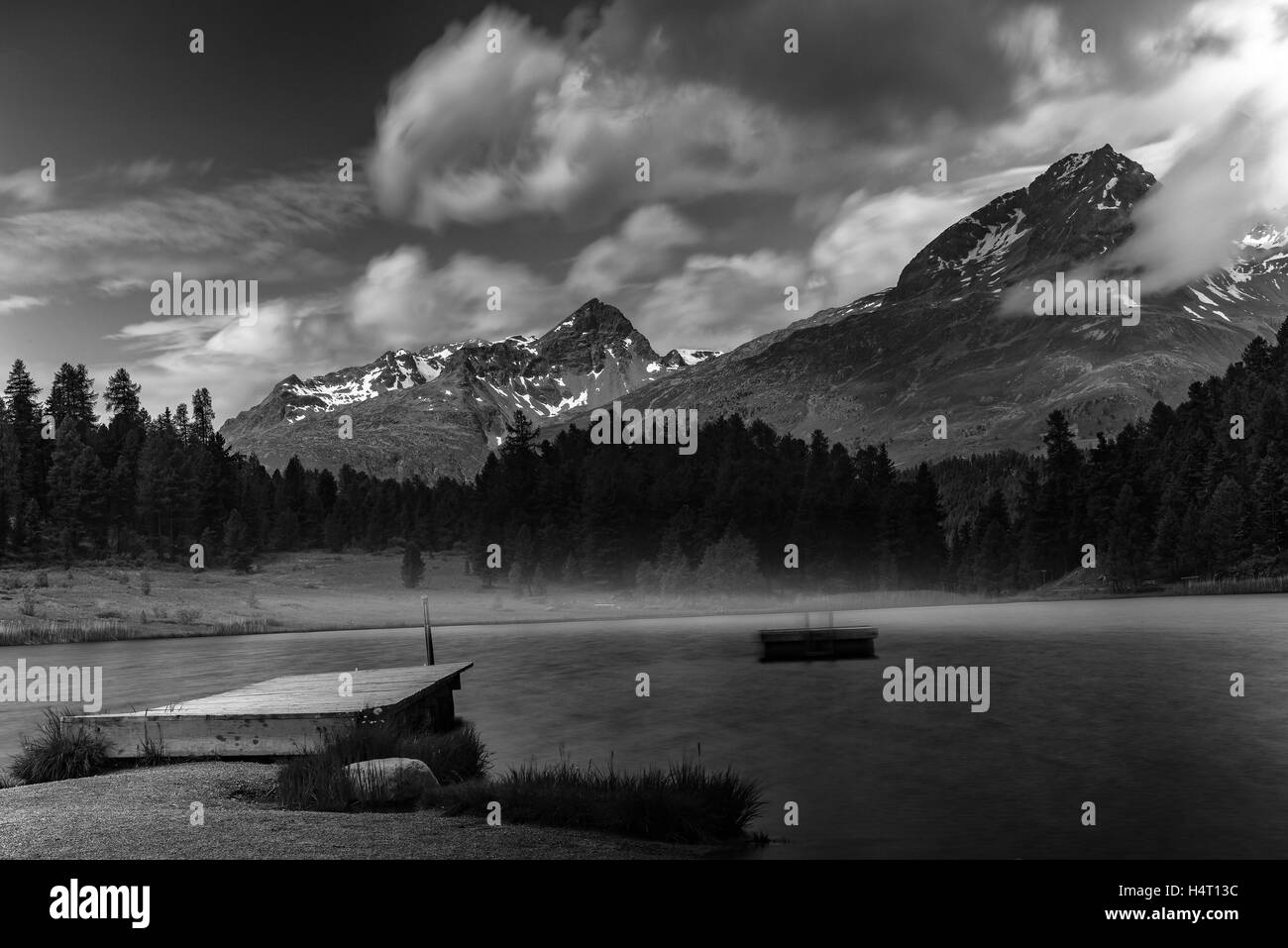 Alpine scenery with lake in the mountains of the Swiss Alps in black and white fine-art Stock Photo