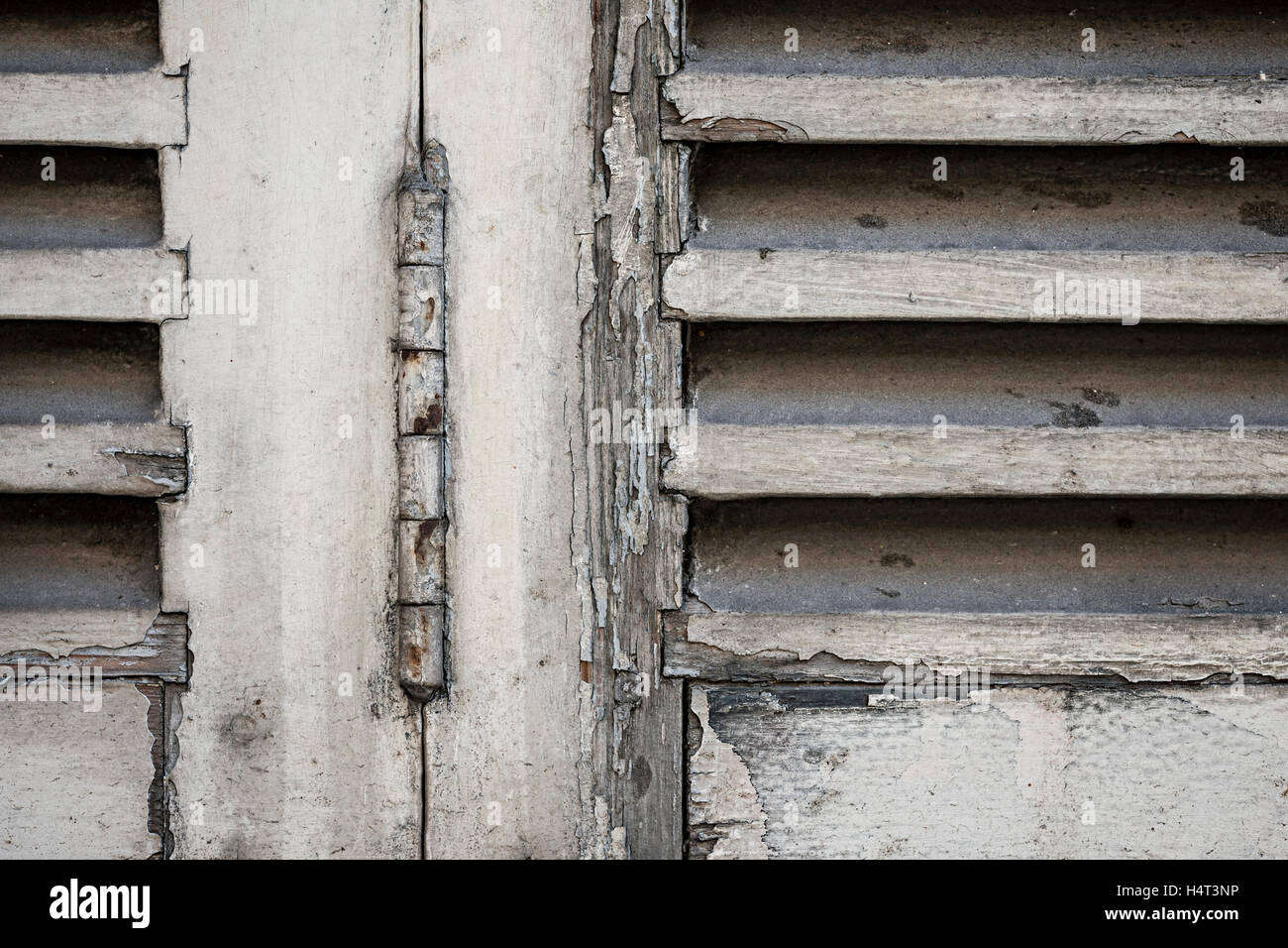 Detail of old wooden closed window shutters with rusty iron hinge and ...