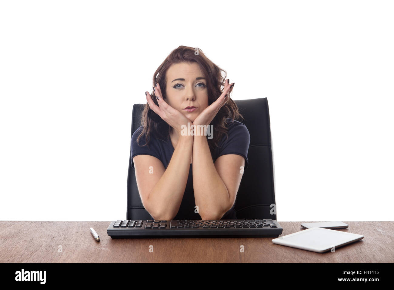 businesswoman sitting at desk looking worried Stock Photo - Alamy