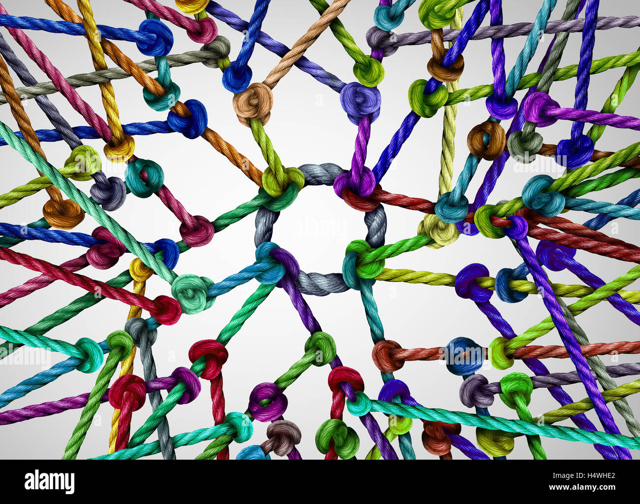 Network center nucleus as a vast diverse group of ropes tied and connected to a centralized circle as a technology and global internet metaphor for being linked together. Stock Photo