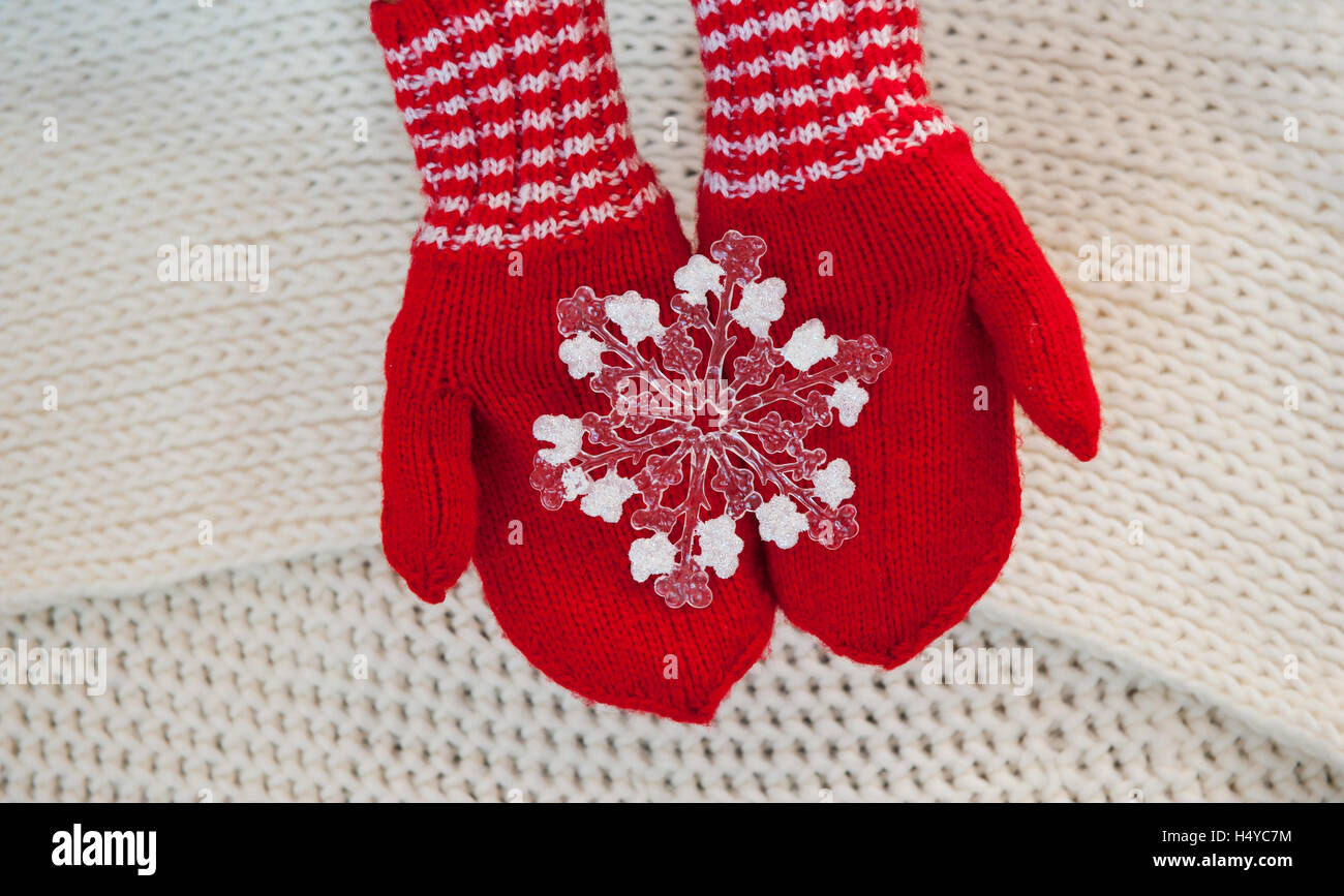 Christmas concept Red mittens with toy snowflake on a white background Stock Photo