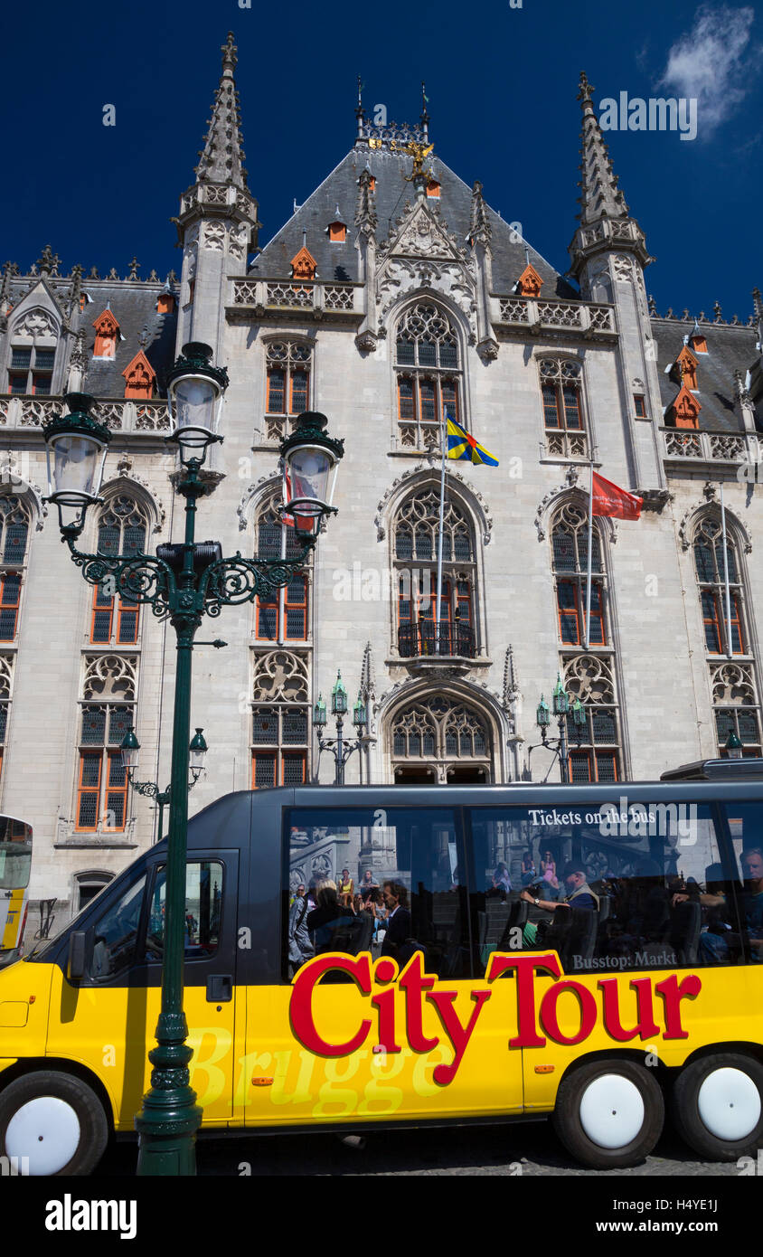 Brugge City Tour Bus in front of the Provincial Court building in Markt, Brugge, Belgium Stock Photo