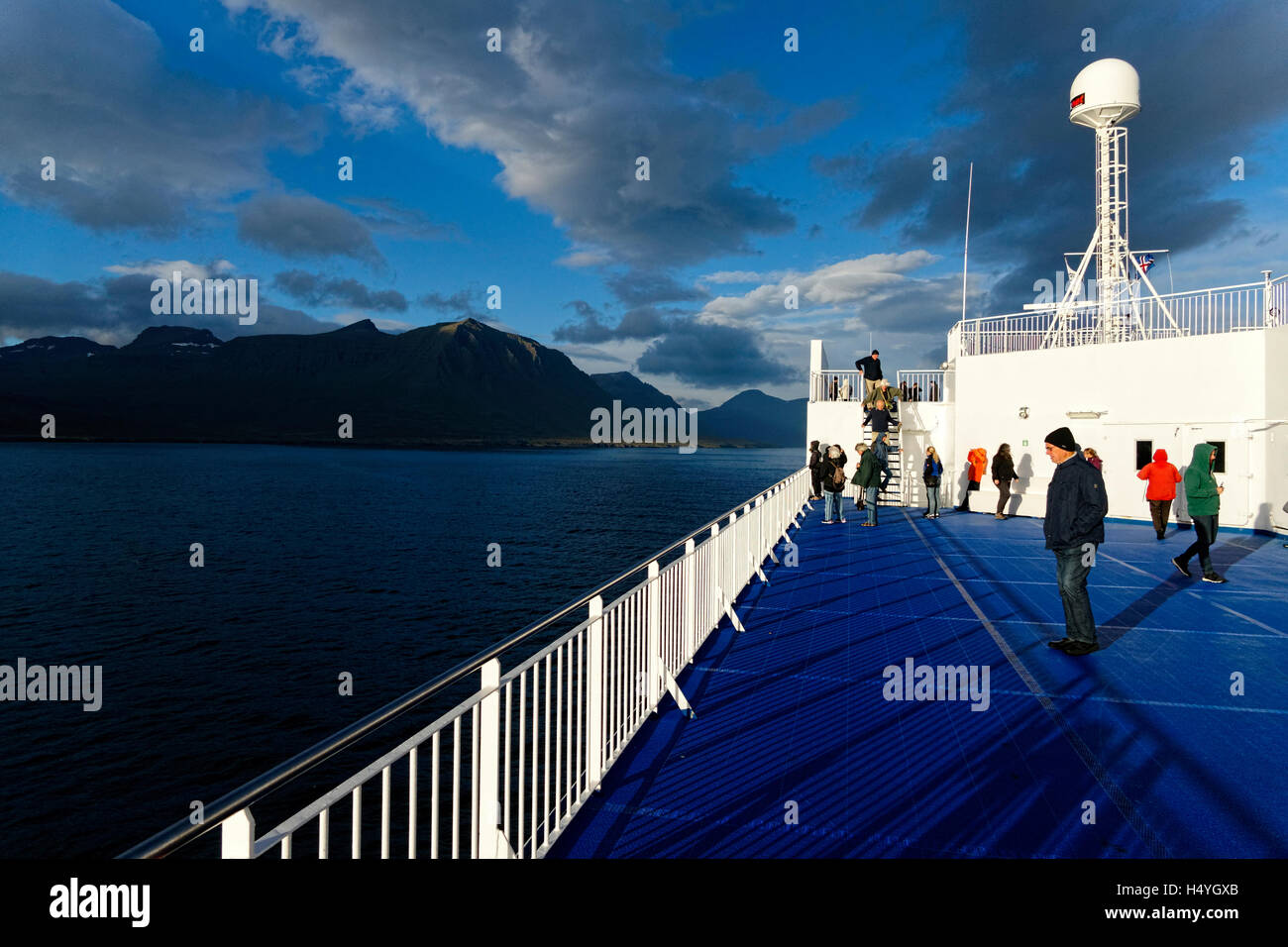 Tourists on ferry boat approaching the eastern Fjord coastline, Iceland, North Atlantic, Europe Stock Photo