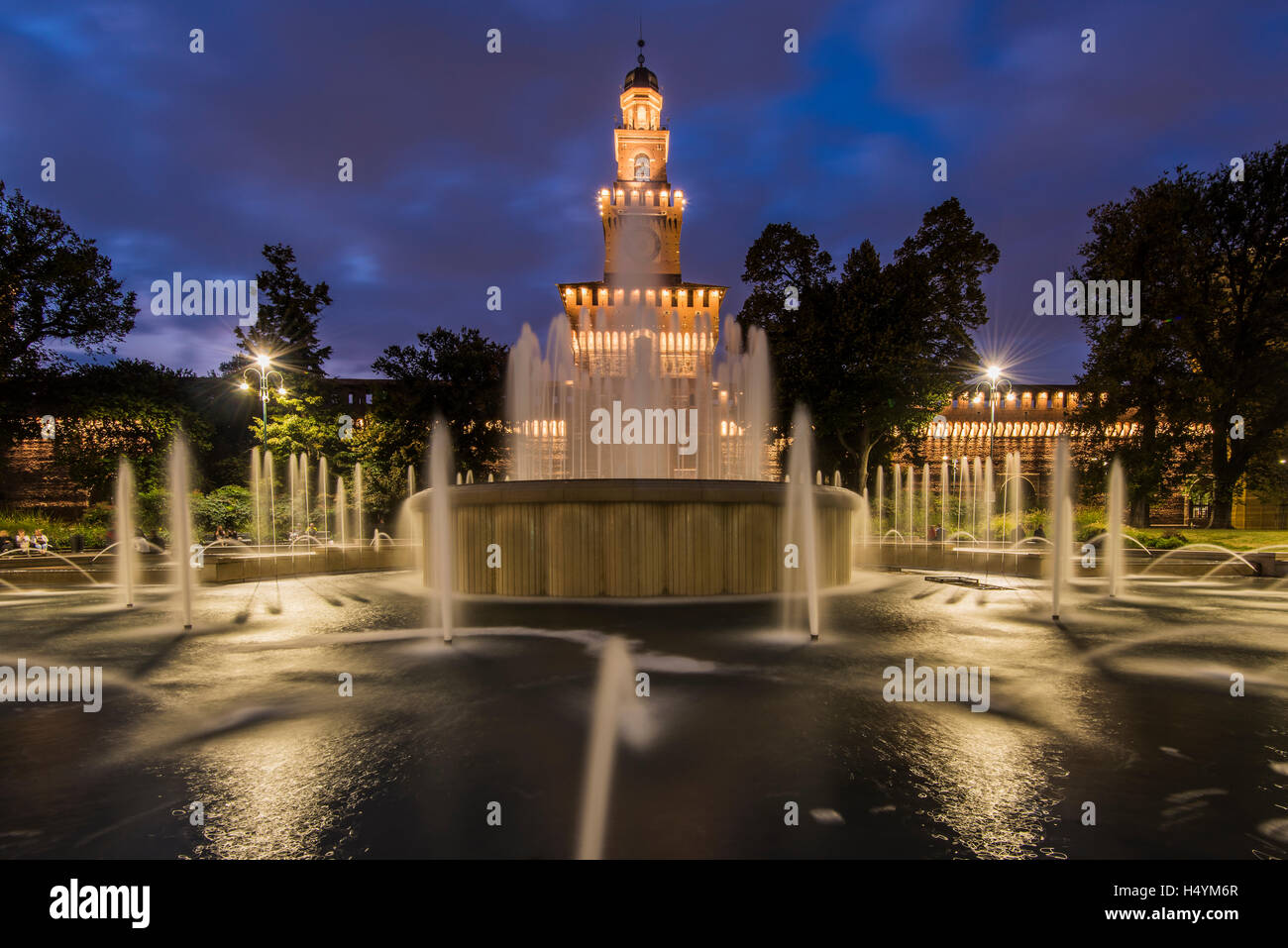 Twilight view of Sforza Castle or Castello Sforzesco and fountain, Milan, Lombardy, Italy Stock Photo