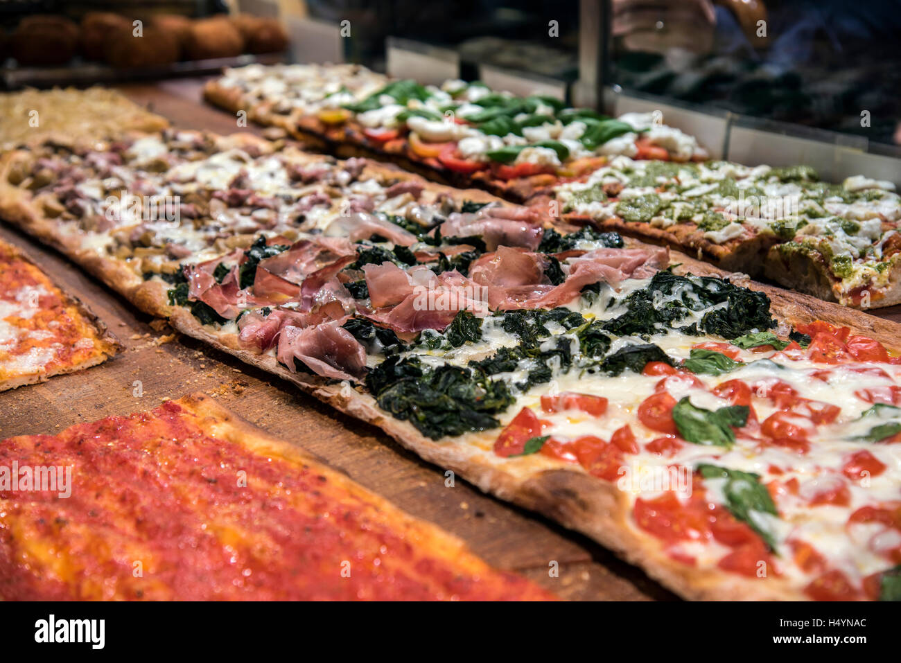 Different varieties of pizza served in a bakery of Trastevere district, Rome, Lazio, Italy Stock Photo