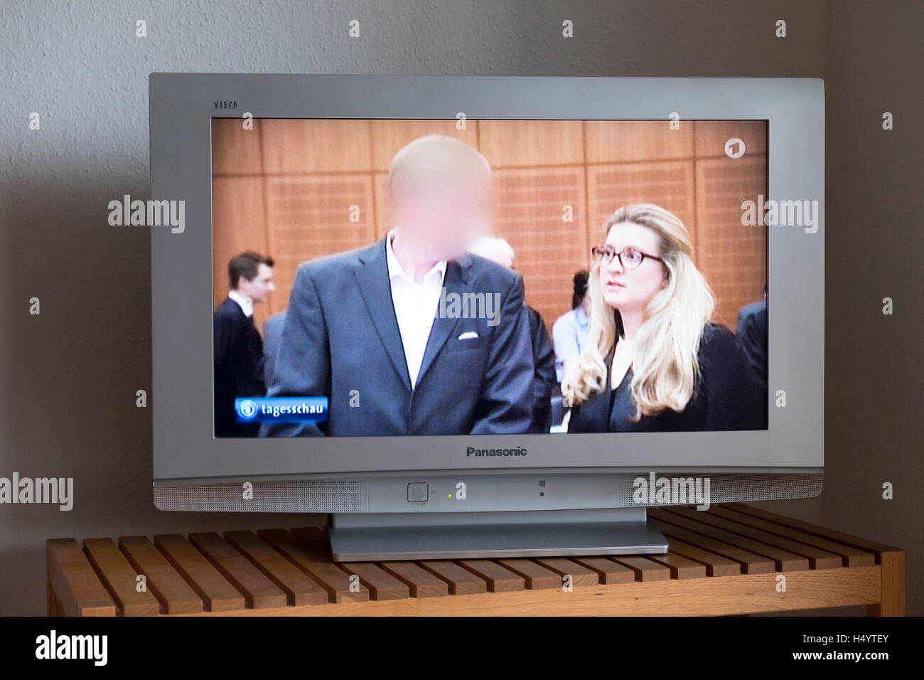 Tagesschau (German daily news show) showing the inside of a German court with face of defendant blurred out Stock Photo