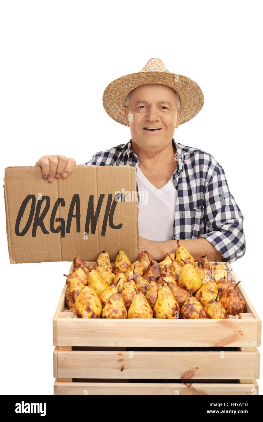 Elderly male farmer posing with a crate full of pears and a cardboard ...