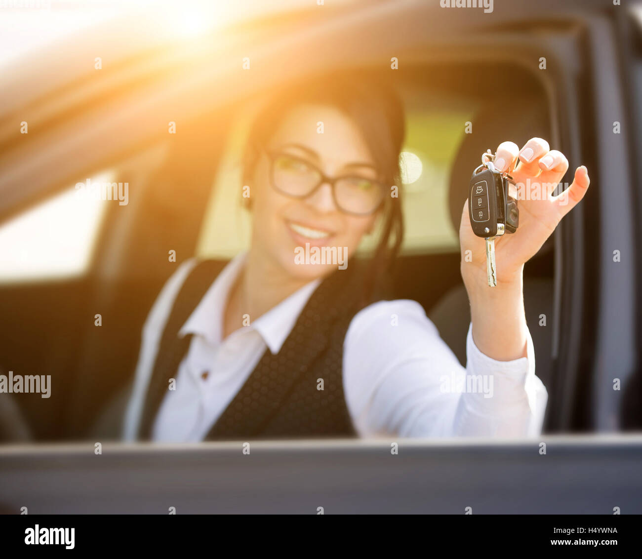 happy smiling young woman with car key Stock Photo