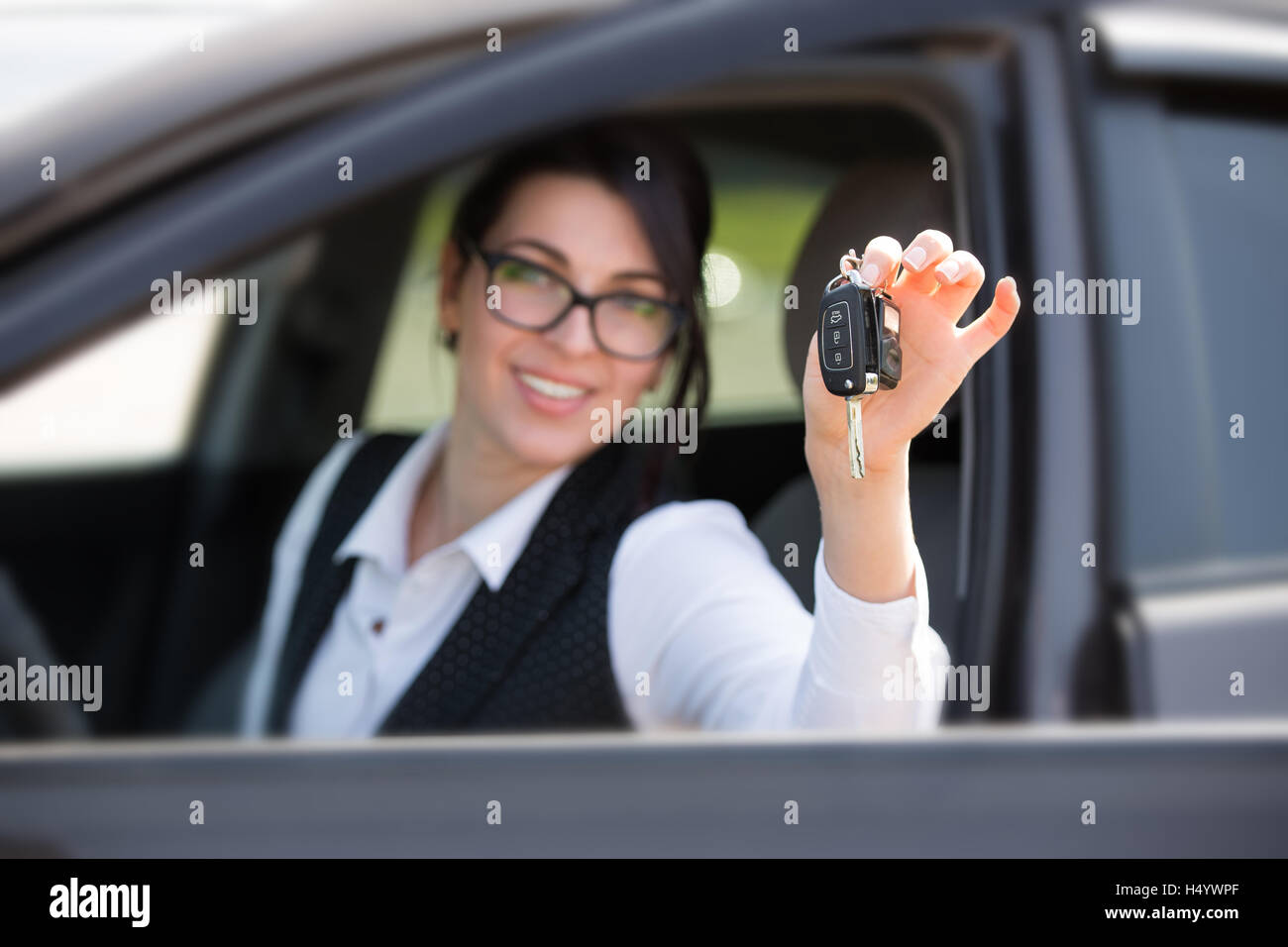 happy smiling young woman with car key Stock Photo