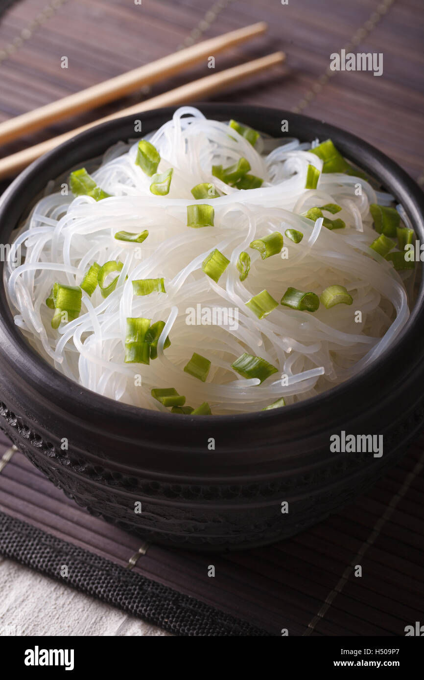 Chinese bean thread noodles in a bowl closeup on the table. Vertical Stock Photo