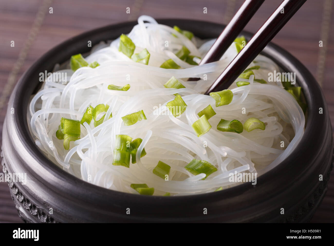 Cellophane noodles with green onions in a bowl closeup on the table. horizontal Stock Photo