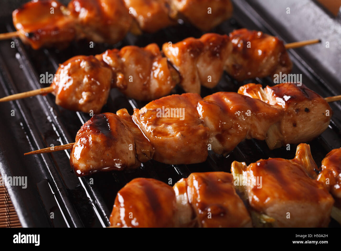 Cooking Japanese yakitori chicken on the grill. closeup horizontal